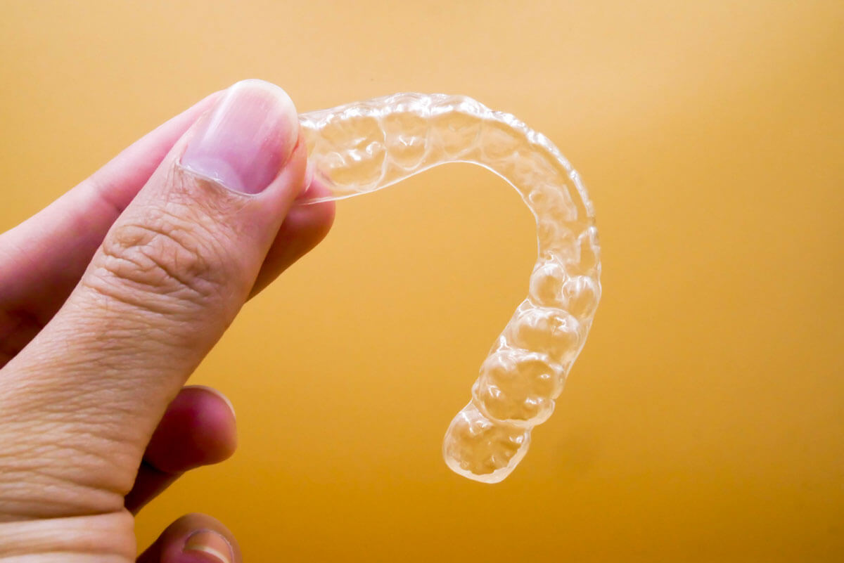 clear aligners on yellow background