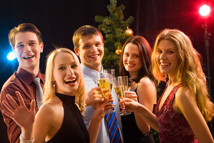 smiling young people toast with champagne flutes